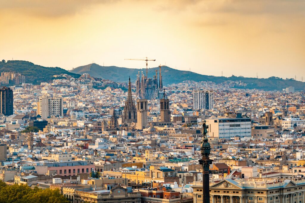 A breathtaking aerial view of Barcelona featuring the iconic Sagrada Familia at sunset.