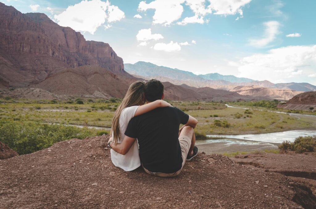 A couple embraces while overlooking the scenic Cafayate landscape in Salta, Argentina.