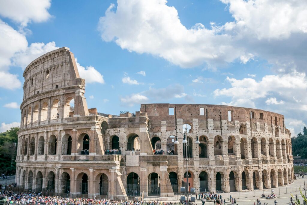 Explore the ancient architecture of Rome with this breathtaking view of the iconic Colosseum under a clear blue sky.