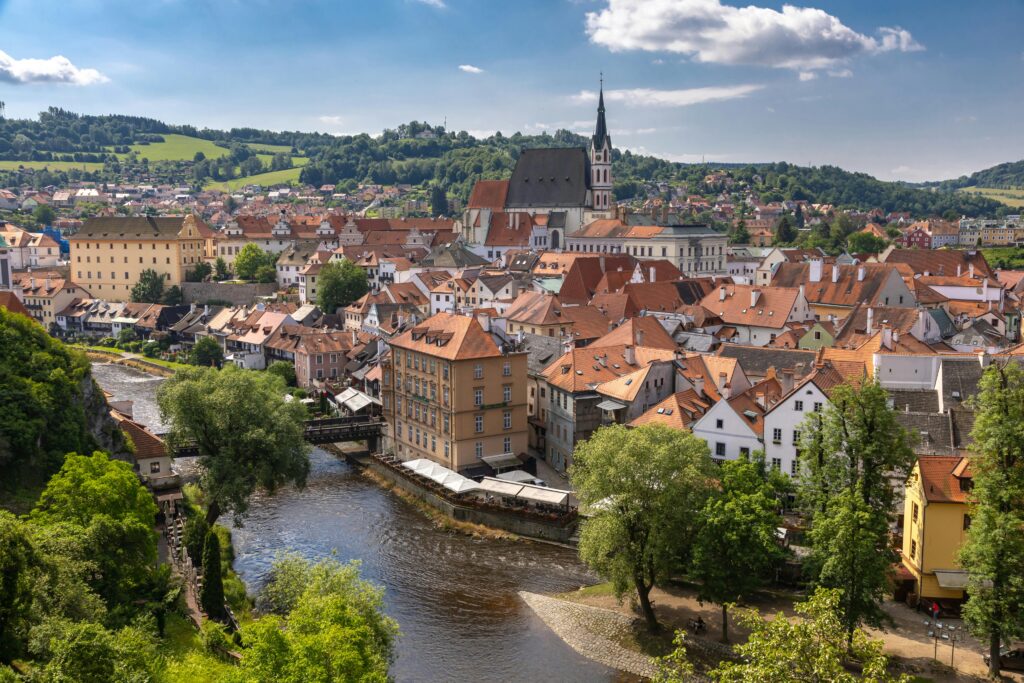 Aerial view of Český Krumlov's historic architecture and the winding Vltava River.